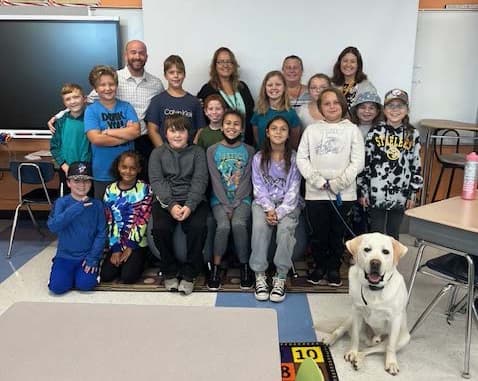 A group of people with a Hickory Ridge Labrador Therapy Dog